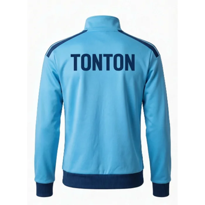 Back view of tonton custom sky blue soccer jacket with navy branding and contrast navy hem.