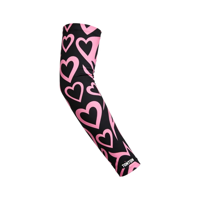 tonton professional volleyball arm sleeve in black with a playful pink heart print pattern and athletic compression fit.